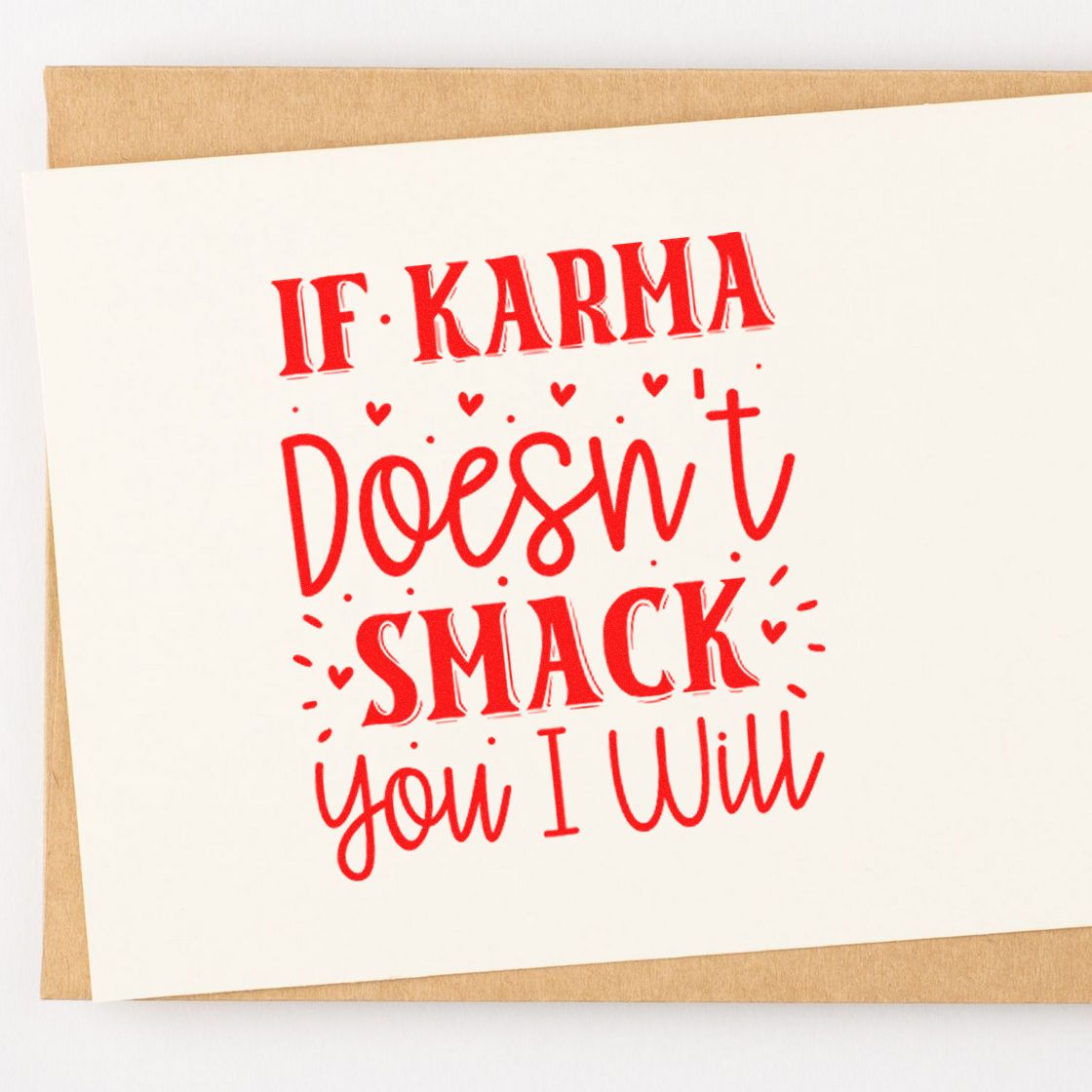 Red stamp and seal design on white card, reading If karma doesnt smack you I will, with small hearts on a tan background.