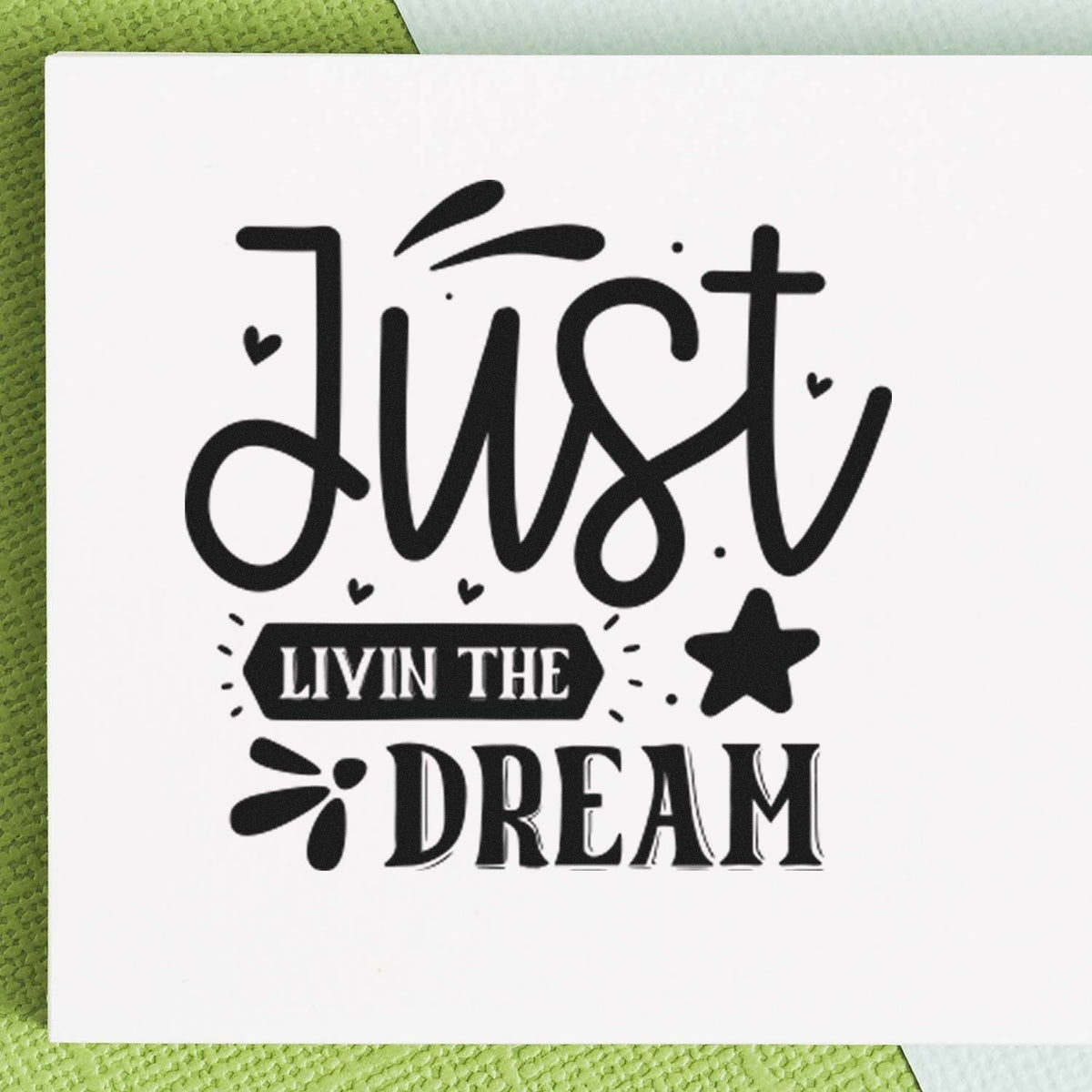 Black custom stamp and seal design reading Just Livin the Dream with hearts, star, and bold lettering on white.