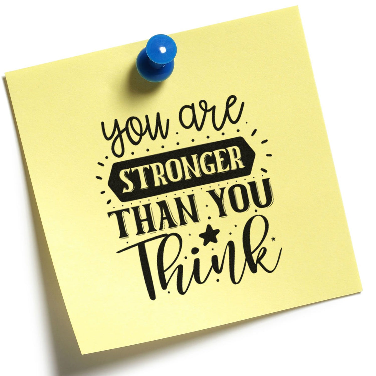 Yellow sticky note with blue pushpin and black rubber stamp-style seal reading You are stronger than you think.