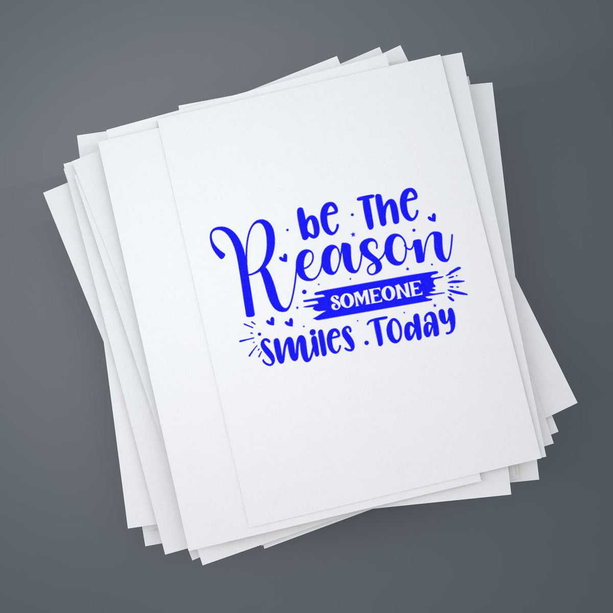 Stack of white sheets with a blue motivational stamp seal reading Be the reason someone smiles today.