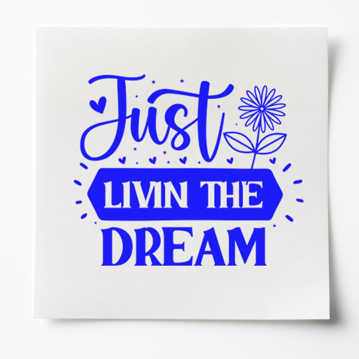Blue custom stamp seal reading Just LIVN THE DREAM with flower, hearts, and stars on white cardstock.