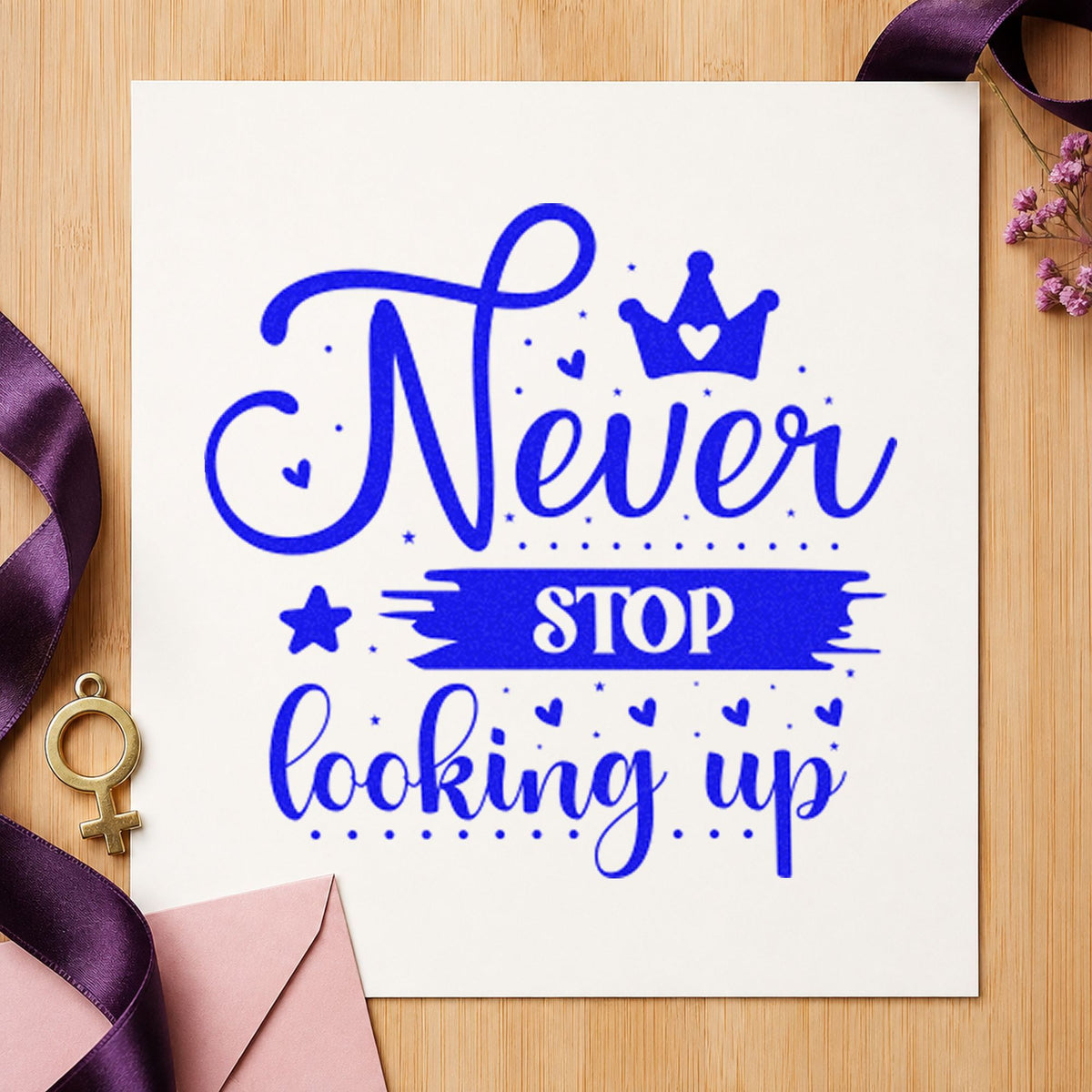 Never Stop Looking Up Crown craft stamp imprinted in blue ink on paper, a design suited to framed yard office.