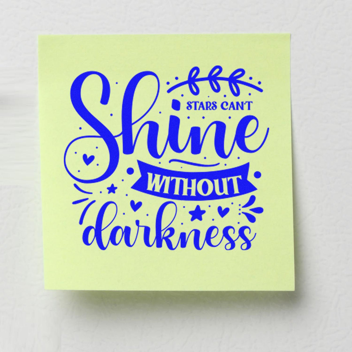 Pale yellow-green rubber stamp design with blue Shine without darkness lettering, stars, hearts, and seal accents.