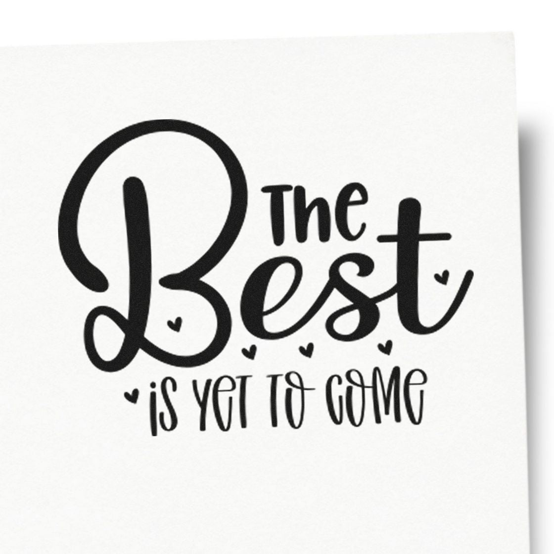 Black stamp and seal design reading The Best is Yet to Come with small hearts on a white background.