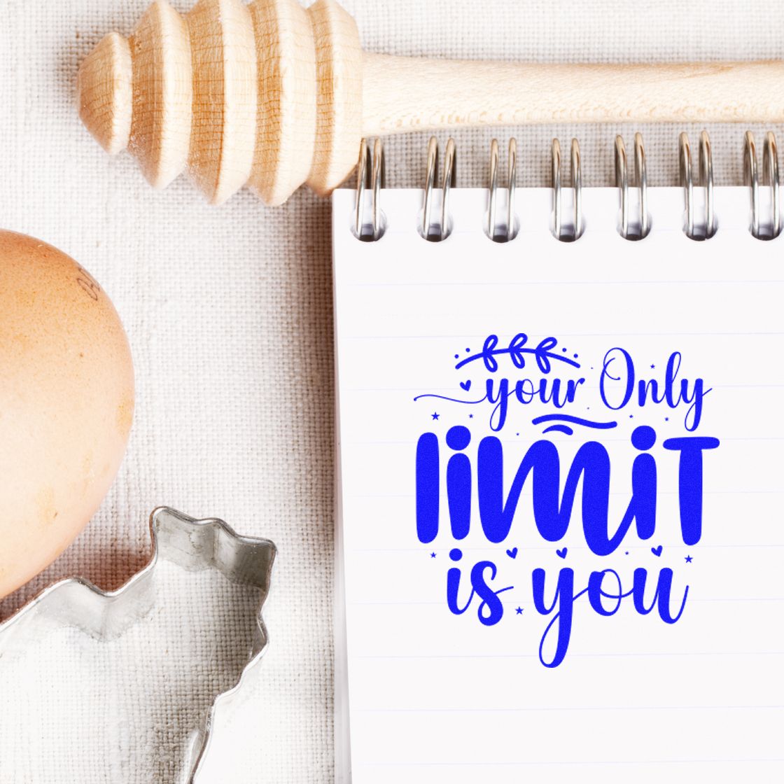 Blue your limit is you stamp on a spiral notebook, with wooden honey dipper, egg, and silver seal cutter.