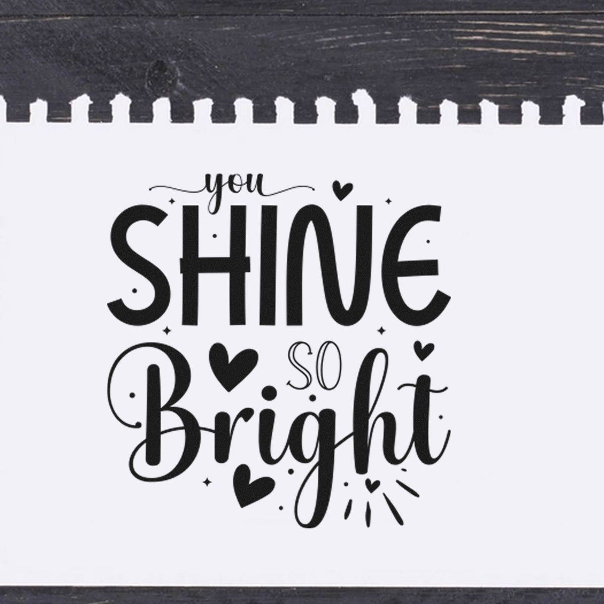 Black-and-white stamp and seal with you shine so bright in playful script, accented by hearts and sparkles.