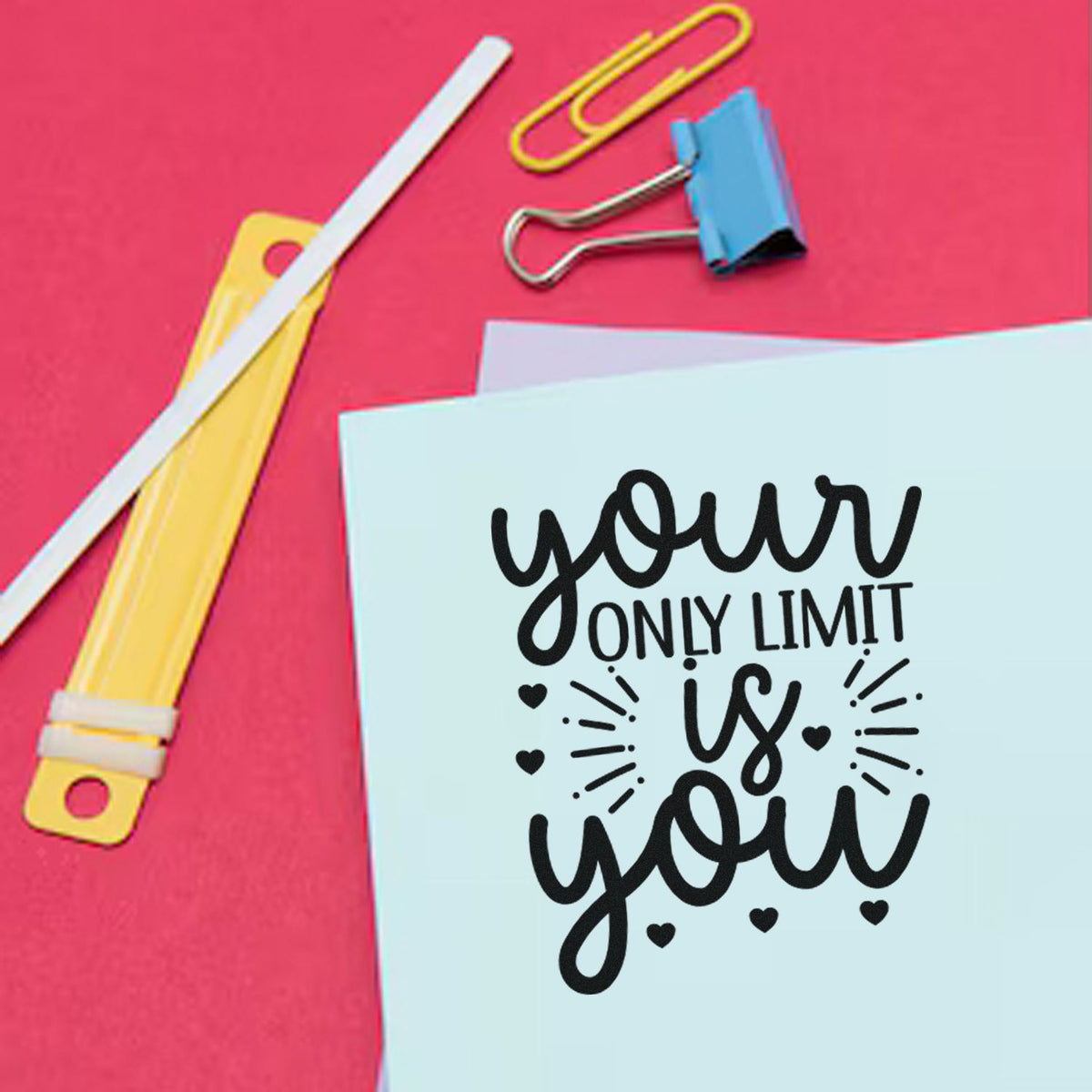 Custom stamp and seal stationery on pink background, with blue card saying your only limit is you and colorful clips.