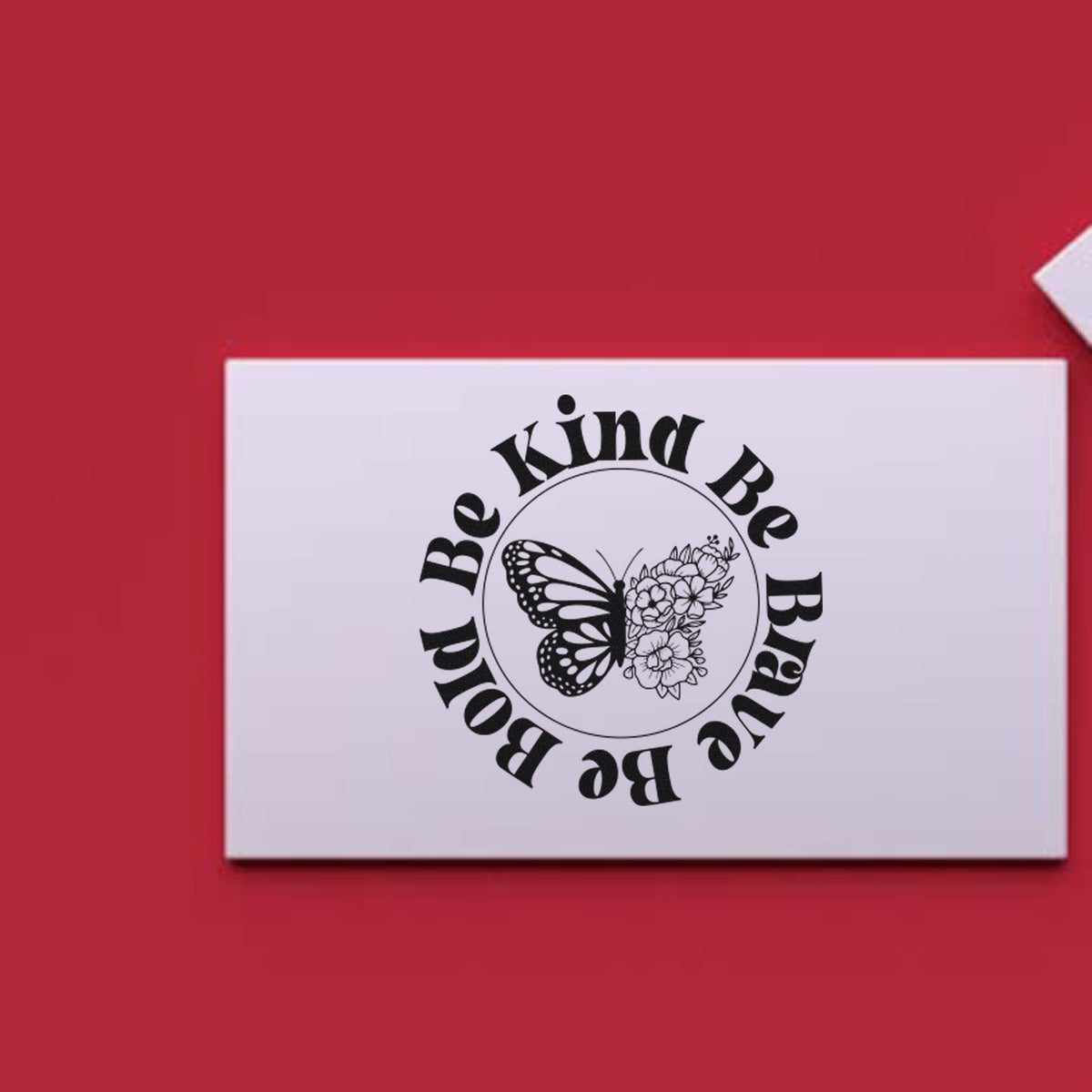 White stamp and seal card on red background with black Be Kind Be Brave butterfly and flower design.
