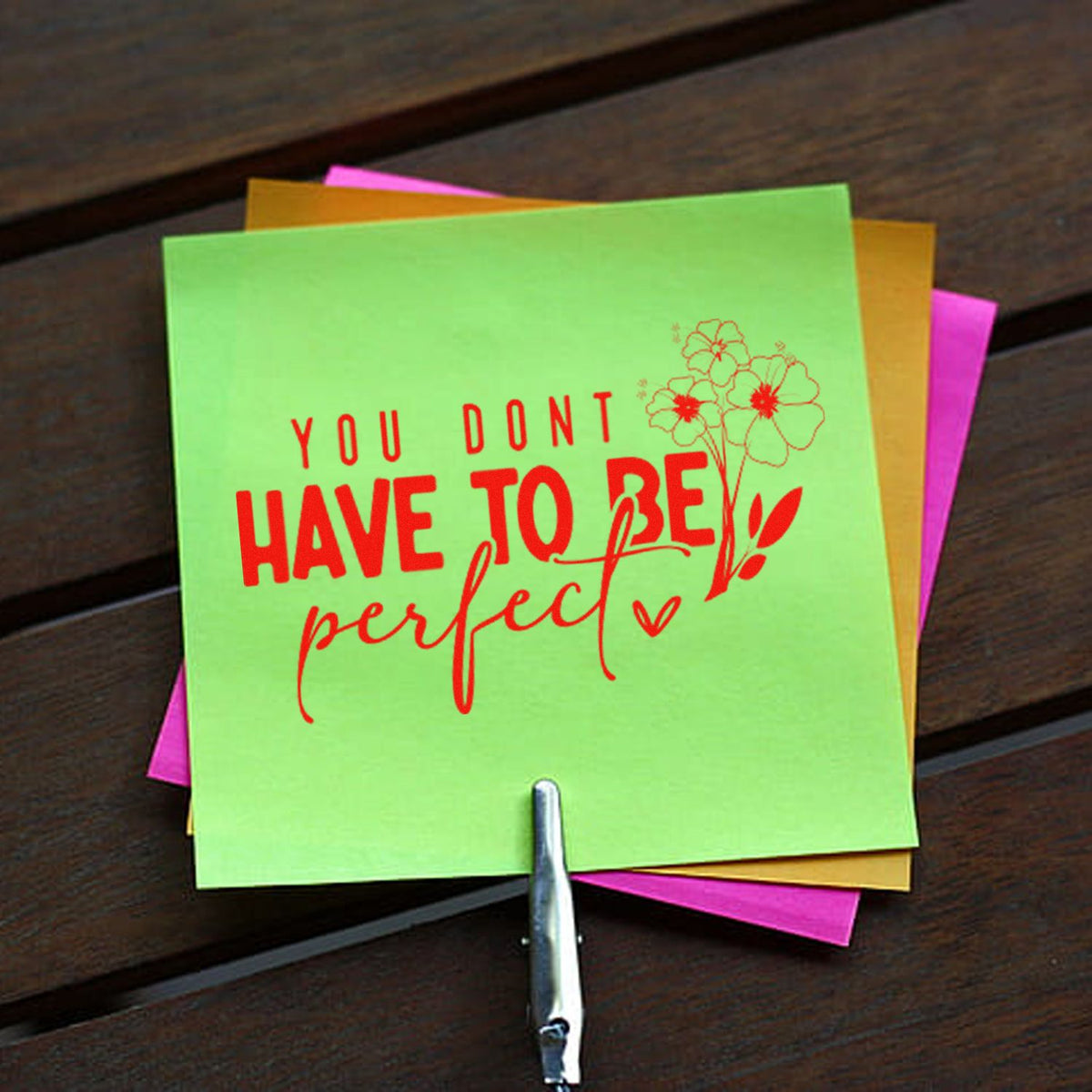 Lime green rubber stamp and floral seal with red You dont have to be perfect text on pink, gold and orange paper.