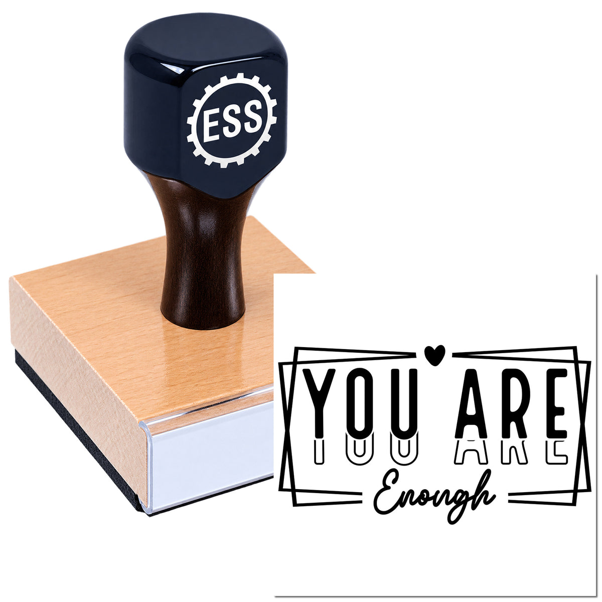 Navy ESS rubber stamp with brown wooden base, printing a black "You Are Enough" seal with heart accent.