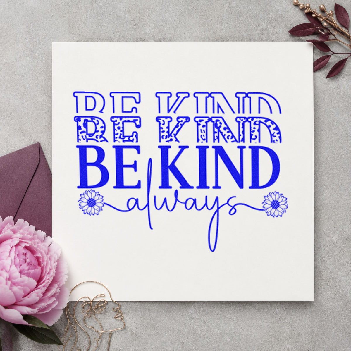 Be Kind Always Repeated craft stamp imprinted in blue ink on paper, a design suited to framed home office.