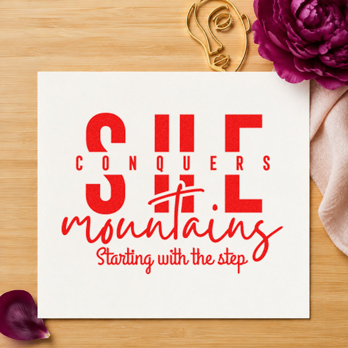 She Conquers Mountains Step rubber stamp shown in red ink, stamped for projects such as bin loaner labels.