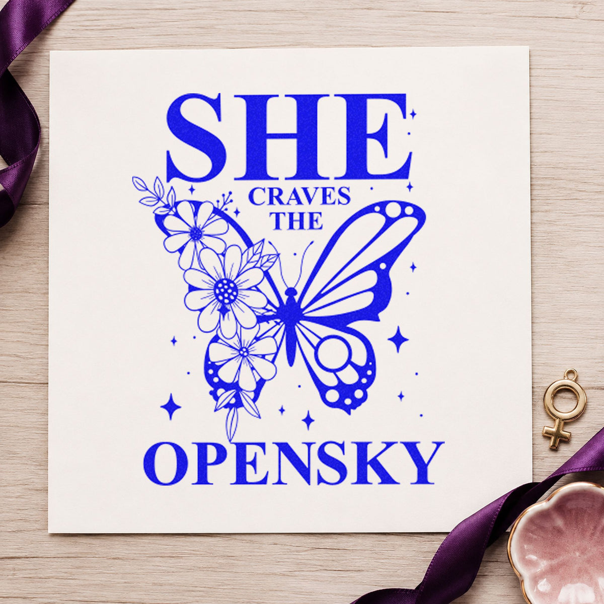 She Craves The Open Sky craft stamp in blue ink on cardstock, an easy option for wing bag printing.
