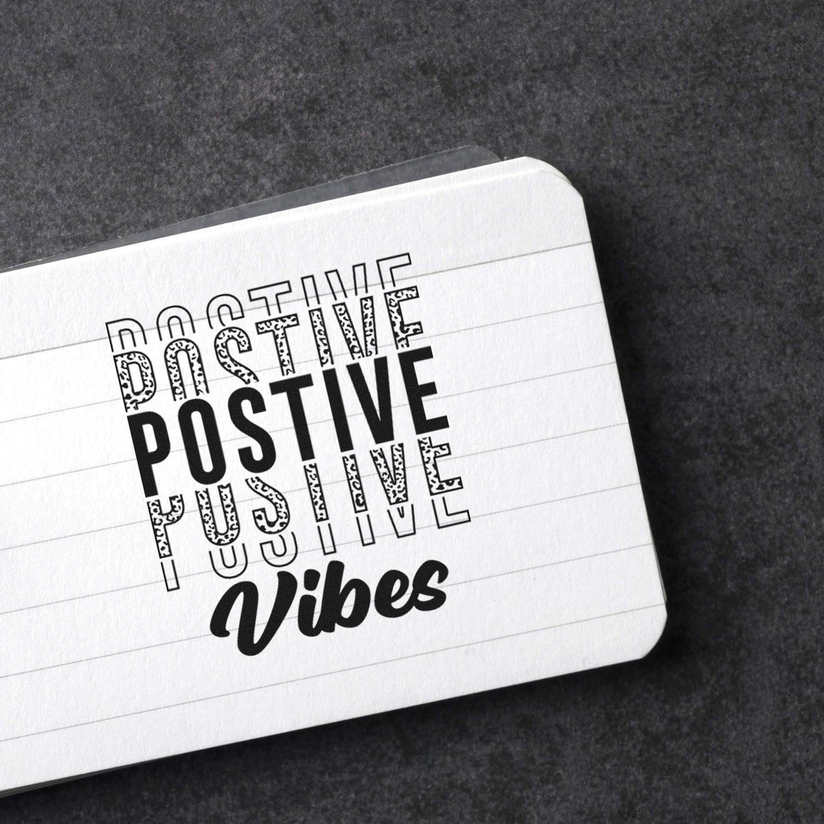 White stamp and seal product card with bold black POSITIVE Vibes lettering on a dark gray background.