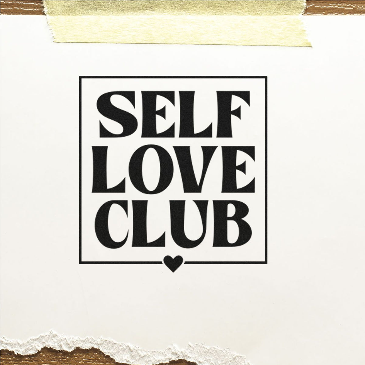 Black SELF LOVE CLUB stamp with heart, framed in a square border on white paper with masking tape and torn edge.
