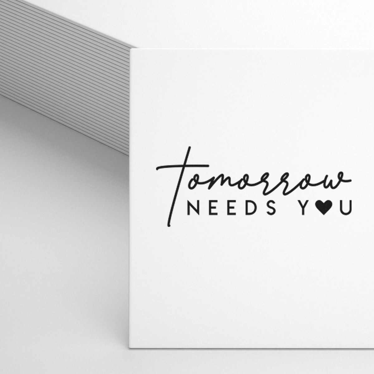 White stamp and seal product with black tomorrow NEEDS Y?U lettering on a clean minimalist white package.
