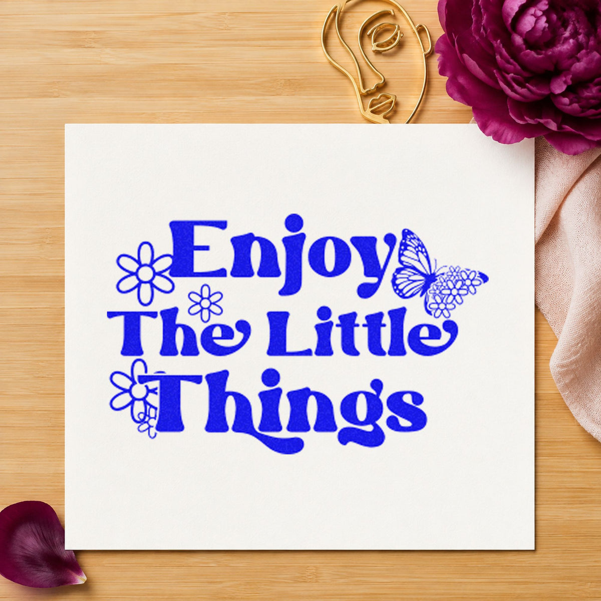 Enjoy The Little Things craft stamp in blue ink on cardstock, an easy option for server pinny printing.