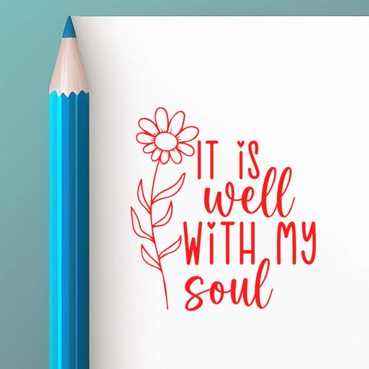 Red floral stamp/seal design reading "It is well with my soul" beside a blue pencil on a white background.