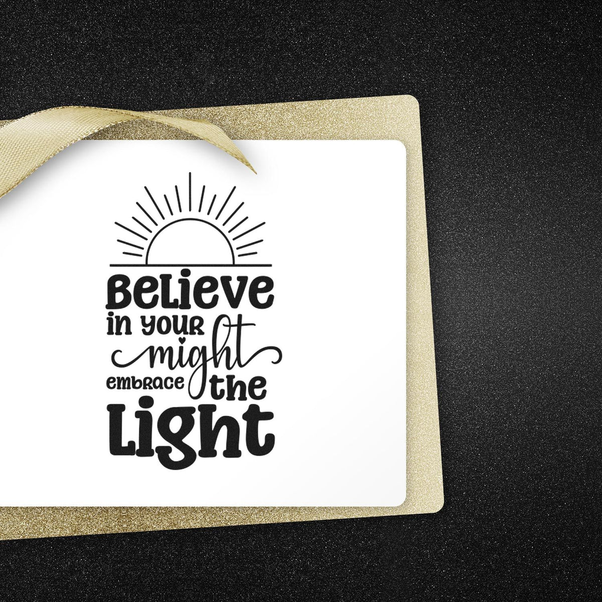 Custom stamp and seal on white card with gold glitter border, black sunburst, and Believe in your might embrace the Light text.