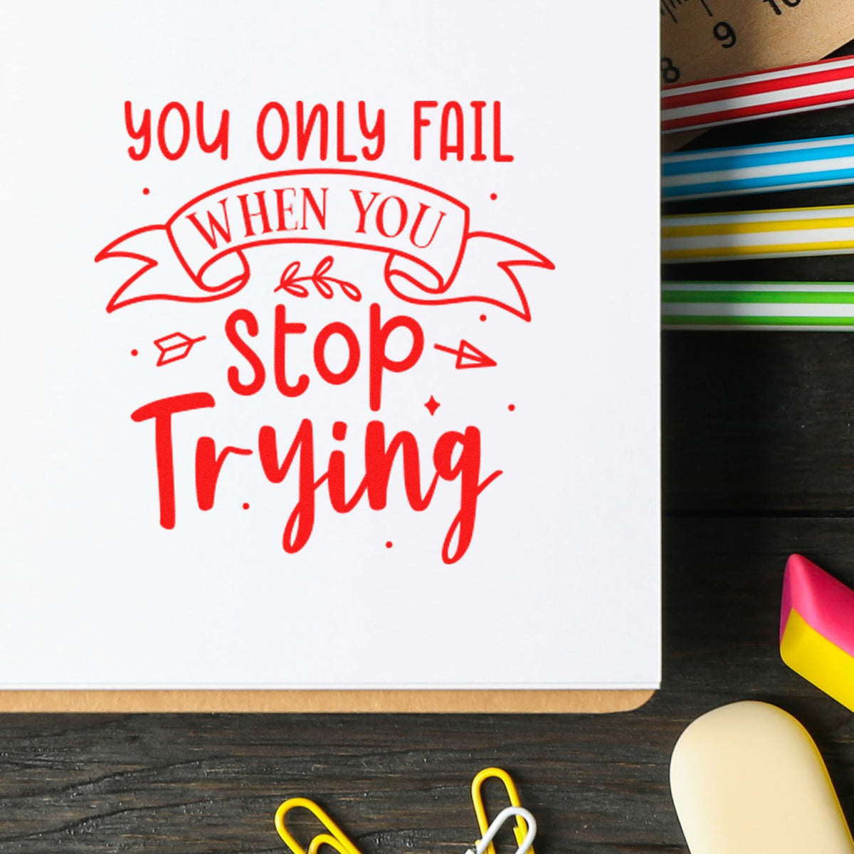 Red rubber stamp design reading You only fail when you stop trying with colorful seal strips and stamp tools.