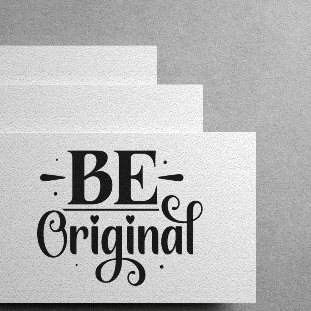 Stacked white textured stamp and seal cards with black BE Original lettering on a gray background.