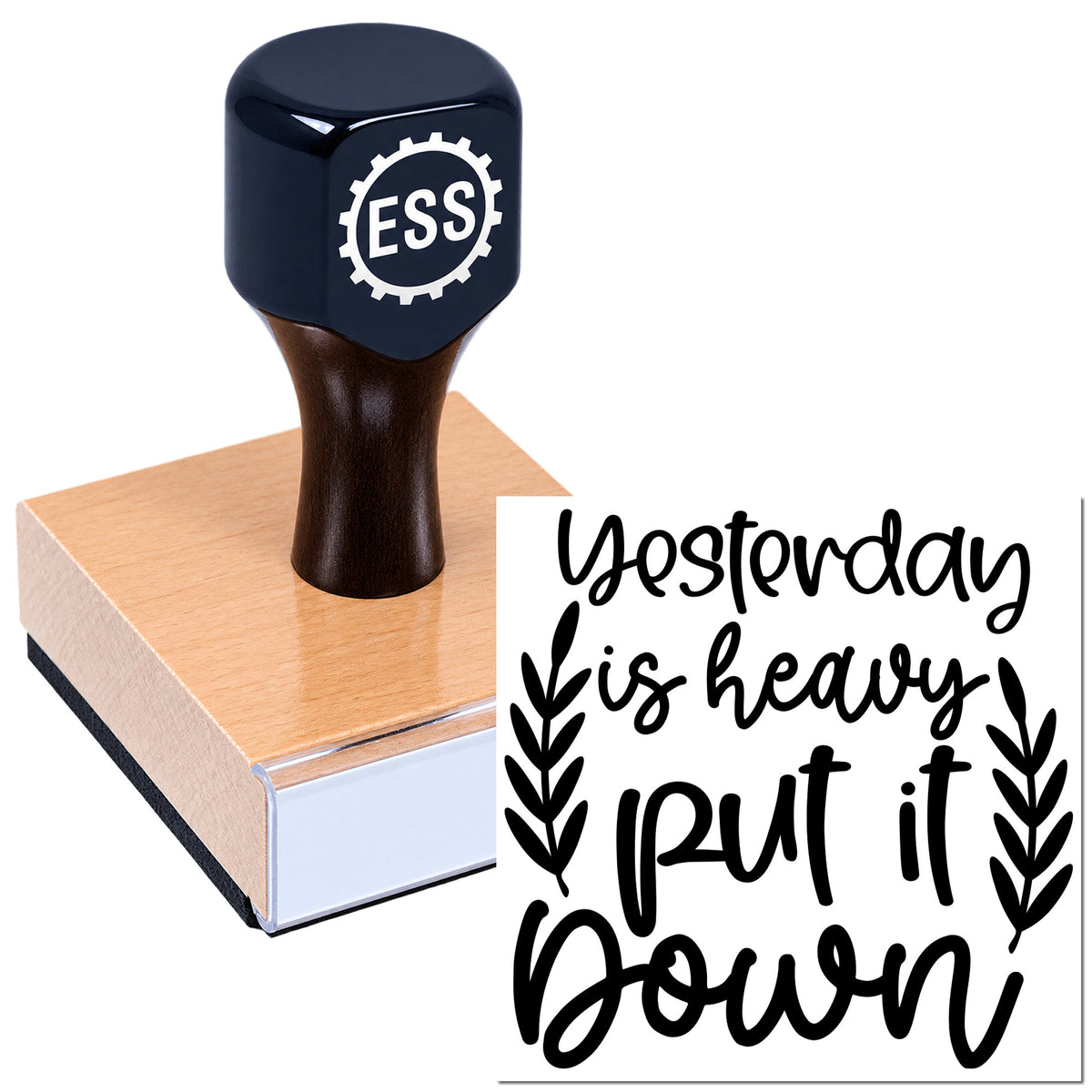 Dark blue rubber stamp with ESS logo on paper, showing black "Yesterday is heavy, put it down" seal design.