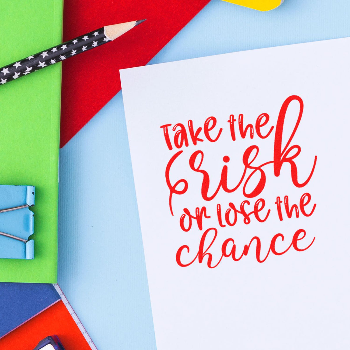 Colorful stamp and seal stationery set with red quote card, star-pattern pencil, and bright green, blue, red, and yellow paper.