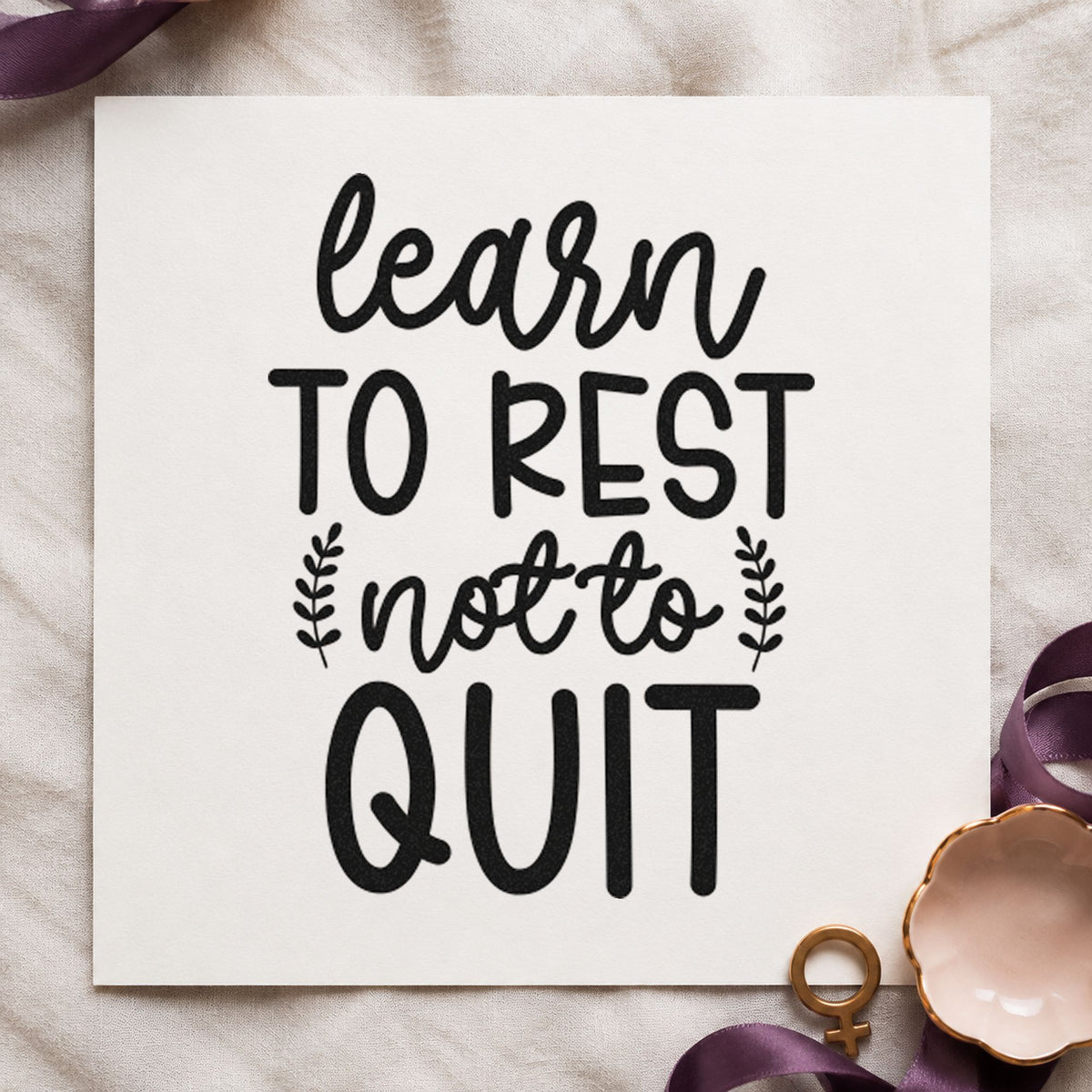 Learn Rest Not Quit craft stamp imprint in black ink on a handmade project, one idea being seed order gift tags.