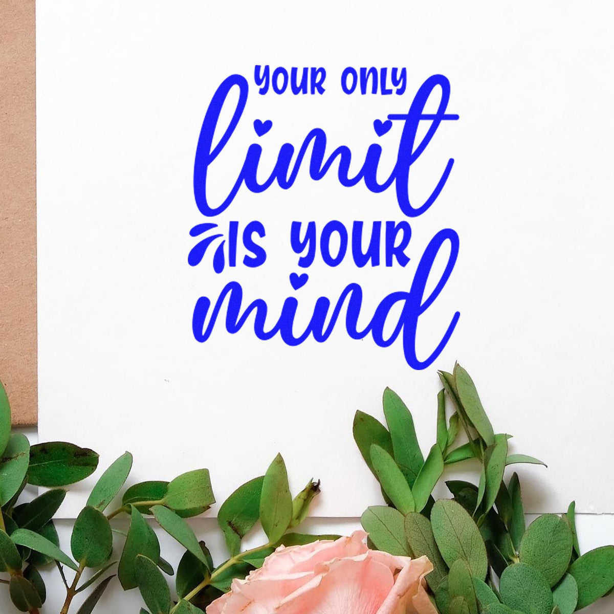 Blue custom stamp and seal reading your only limit is your mind on white card, framed by green leaves and pink rose.