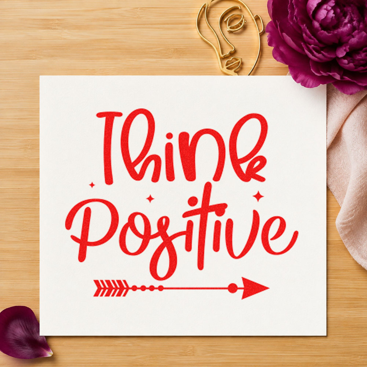 Think Positive Arrow Script craft stamp imprint in red ink on a handmade project, one idea being average log cards.