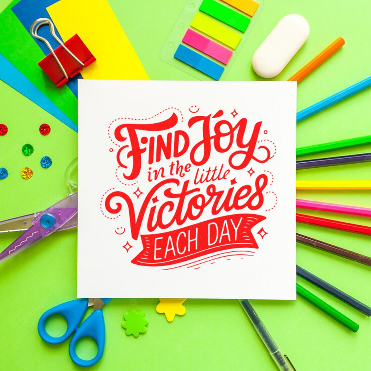 Red stamp-and-seal design on white card, with colorful pens, scissors, clips, and sticky tabs on lime green.