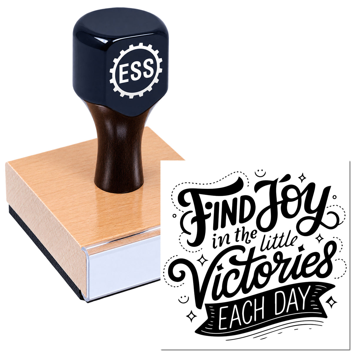 Black ESS custom stamp and seal on wood block, showing a black-and-white "Find joy in the little victories each day" design.