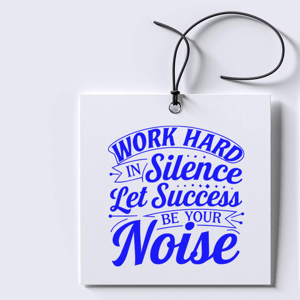 Blue custom stamp and seal on white hanging card with black cord, reading Work Hard in Silence Let Success Be Your Noise.