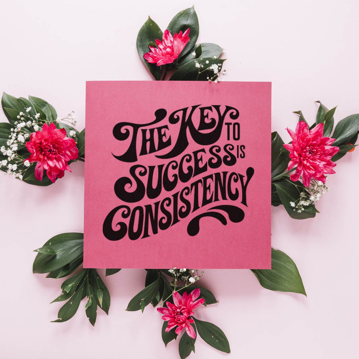 Pink custom stamp-and-seal card with black The key to success is consistency lettering, framed by green leaves and hot pink flowers.
