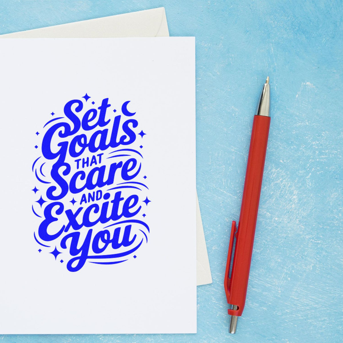 Custom stamp card with blue Set Goals That Scare and Excite You lettering beside a red pen on a light blue background.
