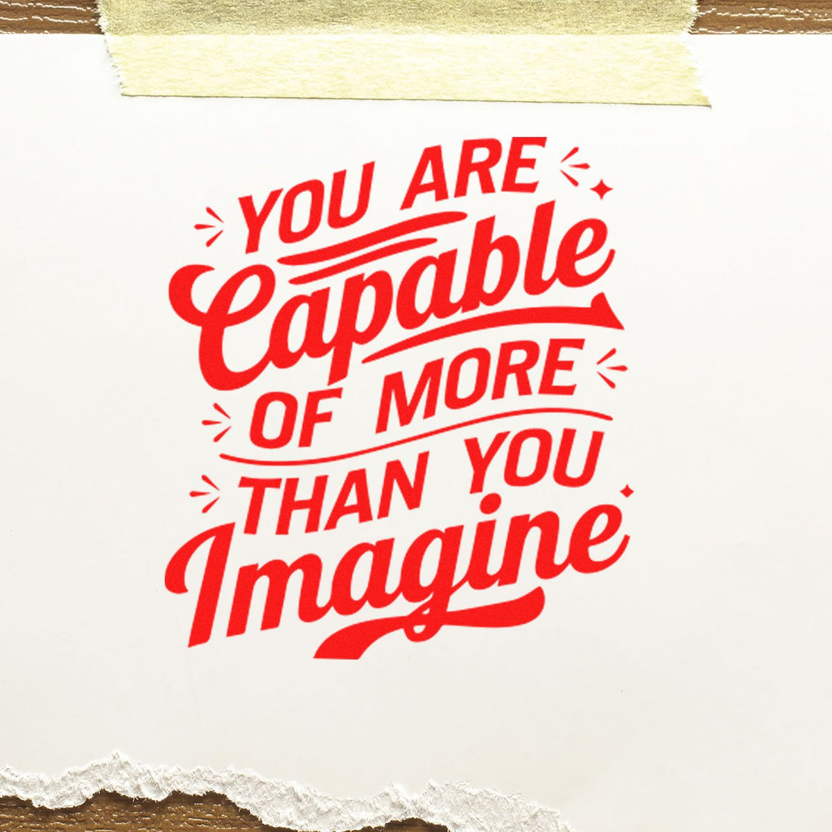 Red rubber stamp-style seal on white paper reads, You are capable of more than you imagine.