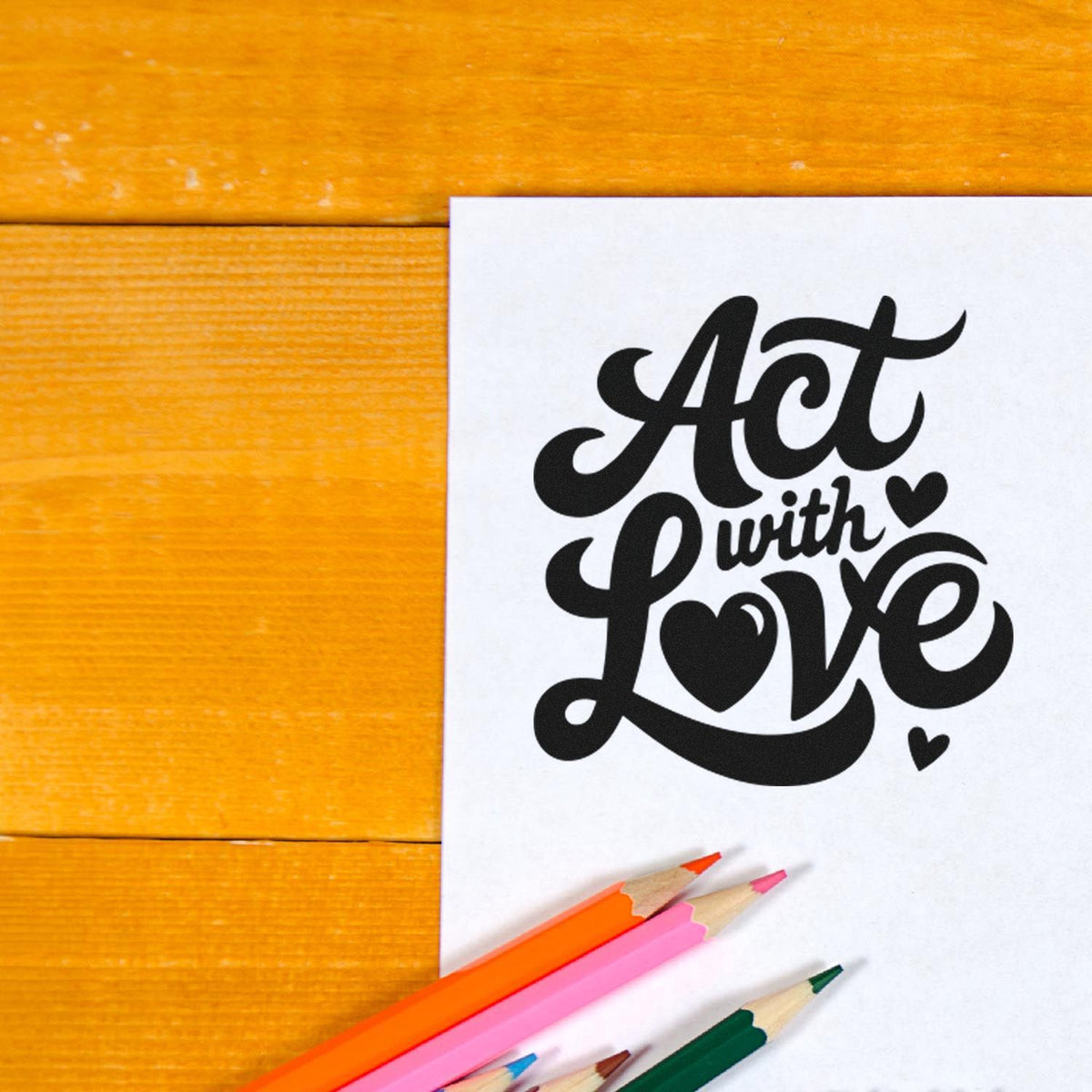 Act With Love Hearts Premium Wood-Mounted Stamp - Vintage Pro imprint stamped in black ink. Act with Love appears in bold flowing lettering with solid hearts.