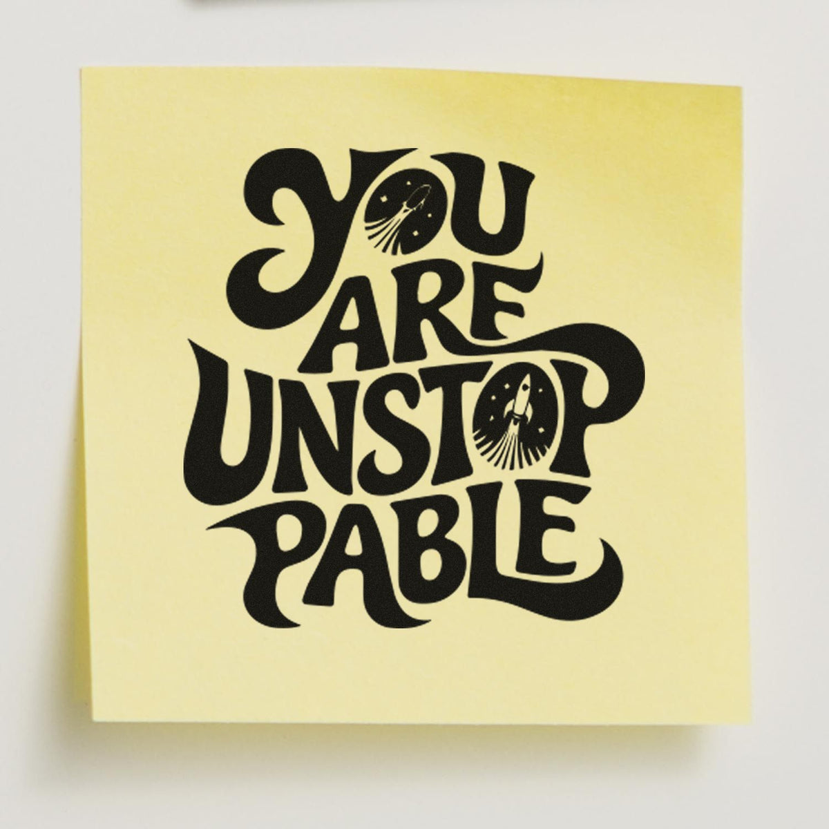Black You Are Unstoppable rubber stamp seal on a pale yellow card with rocket icons.