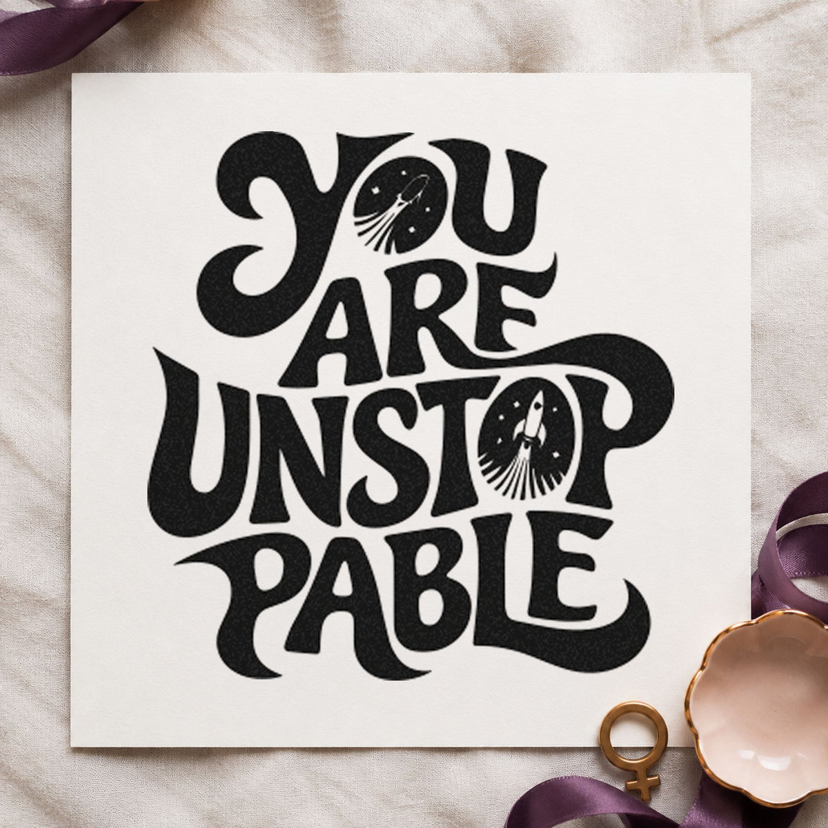 You Are Unstoppable Lettering craft stamp imprint in black ink on a handmade project, one idea being tape roll gift tags.