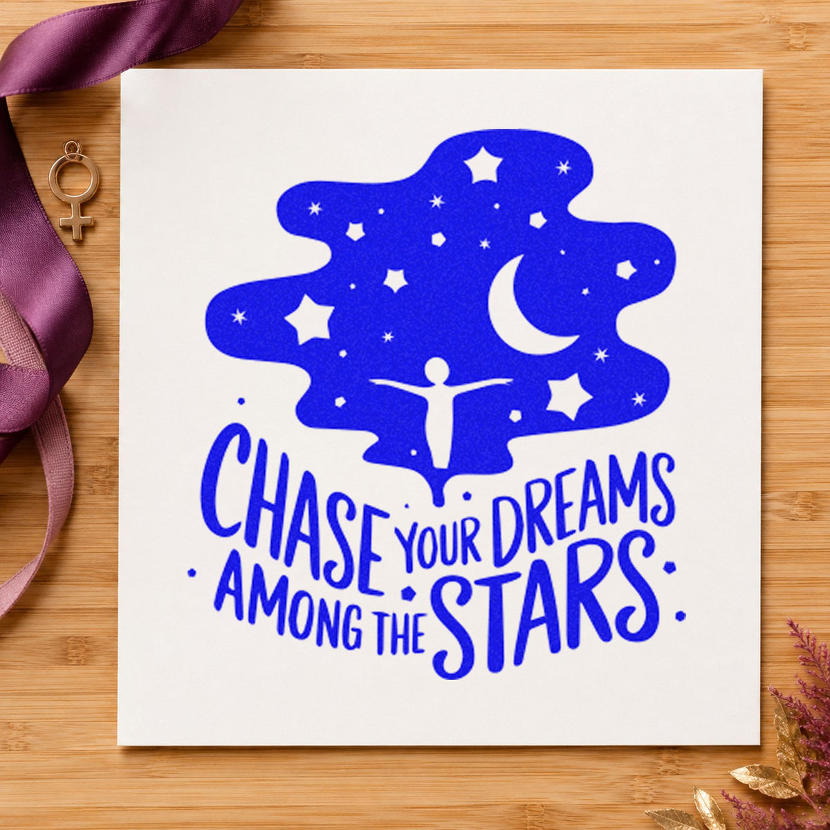 Chase Dreams Among Stars craft stamp imprinted in blue ink on paper, a design suited to framed dark room.