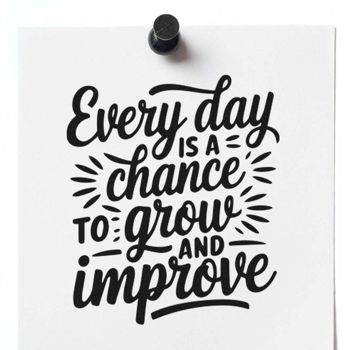 Black rubber stamp seal on white paper with motivational text: Every day is a chance to grow and improve.
