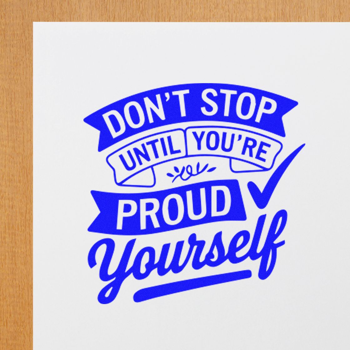 Blue motivational stamp and seal reading Dont stop until youre proud of yourself on white paper.
