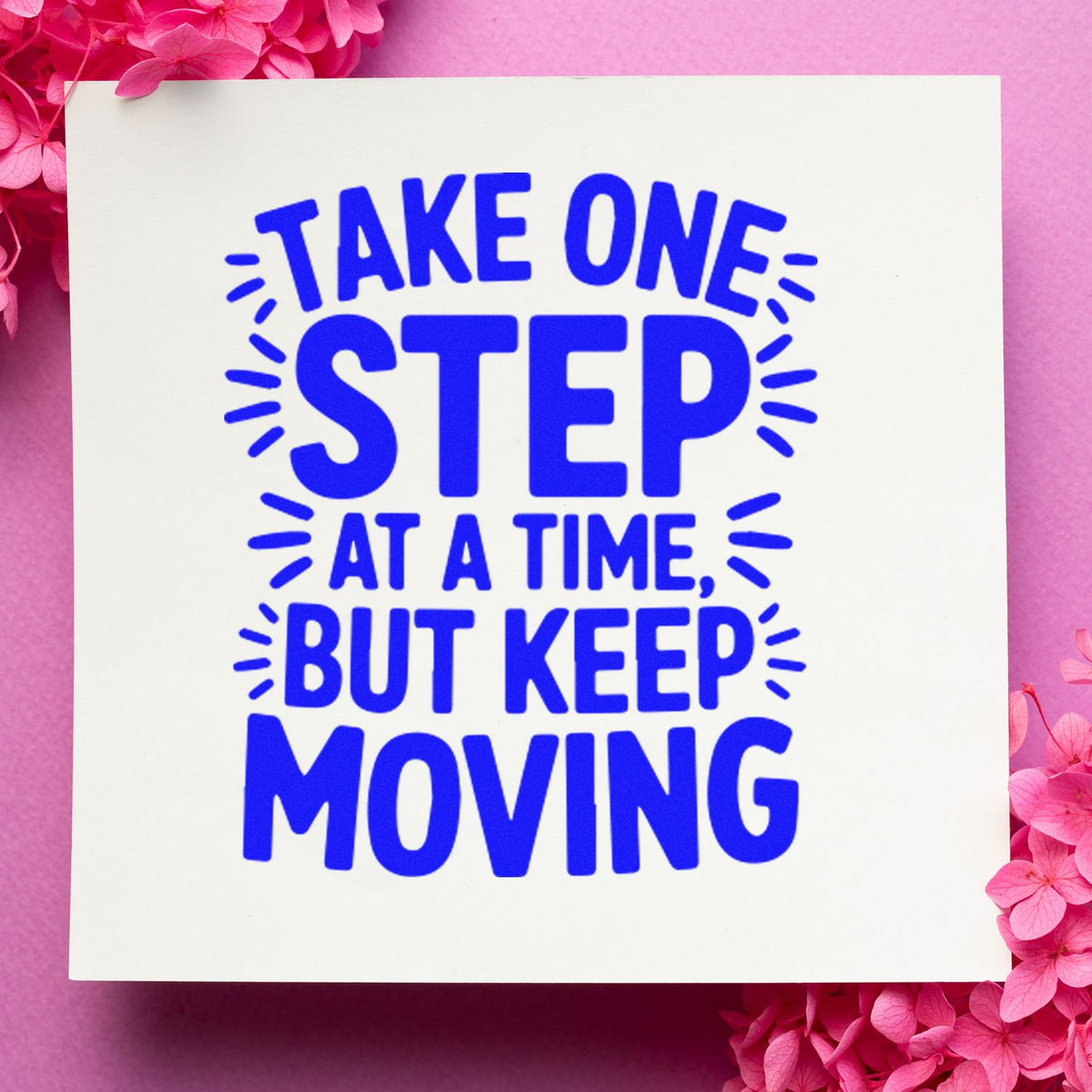 Blue rubber stamp design reading Take one step at a time, but keep moving on white card with pink flowers.