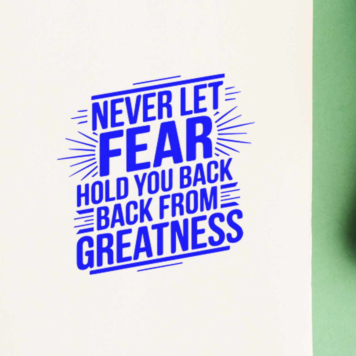 Blue motivational rubber stamp seal reads Never let fear hold you back from greatness on white with green edge.