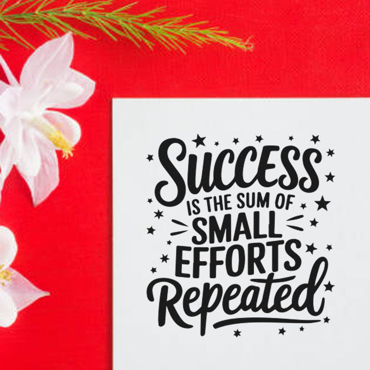 Decorative stamp/seal with black quote Success is the sum of small efforts repeated on white, set on a red floral background.