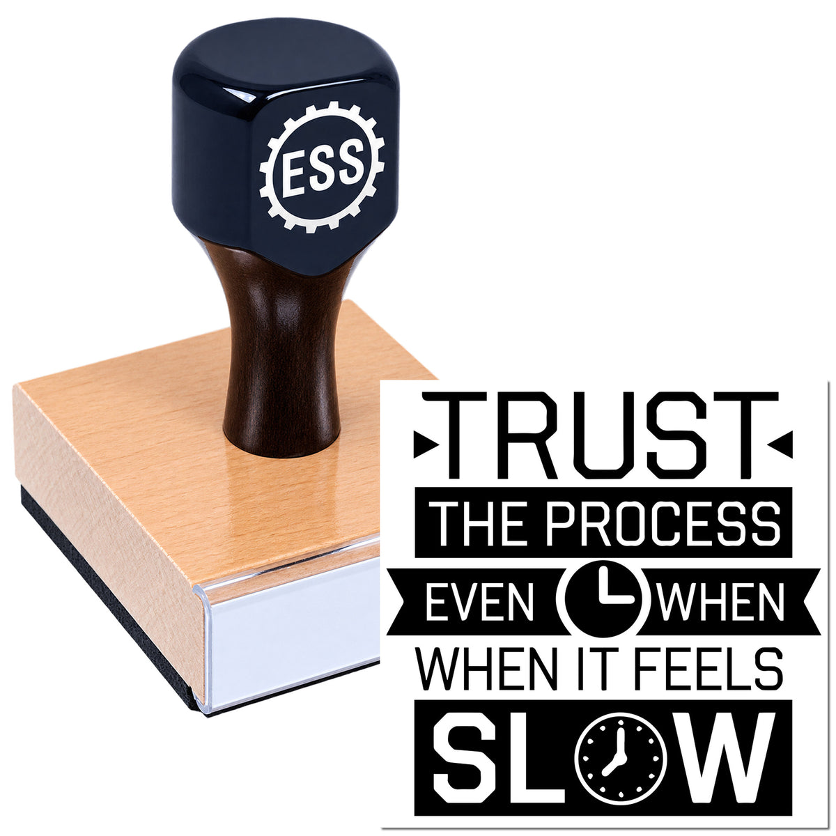 Black seal stamp on a pink wooden block with bold "Trust the Process" slogan, black and white design.