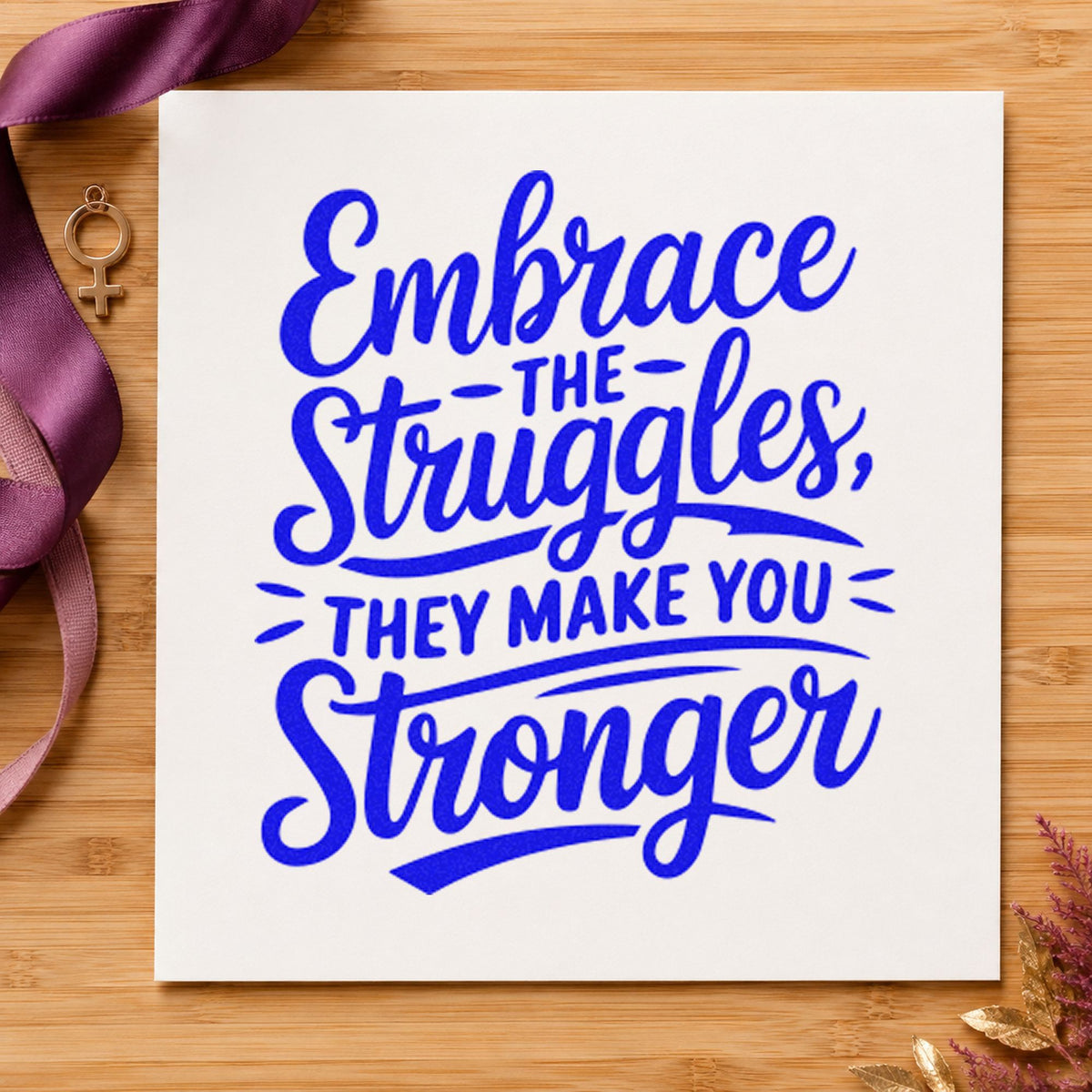 Embrace Struggles Make Stronger craft stamp imprinted in blue ink on paper, a design suited to framed carrel corner.