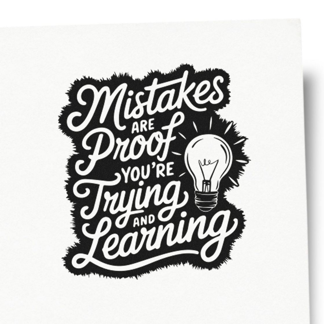 Black and white rubber stamp seal with light bulb and quote: Mistakes are proof youre trying and learning.