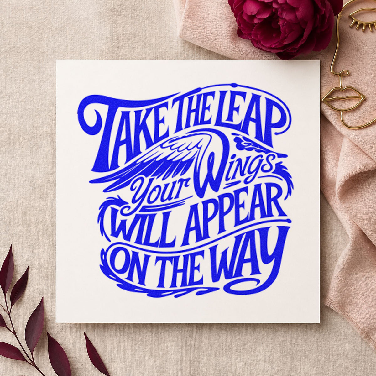 Take Leap Wings Appear craft stamp in blue ink on cardstock, an easy option for bench cloth printing.