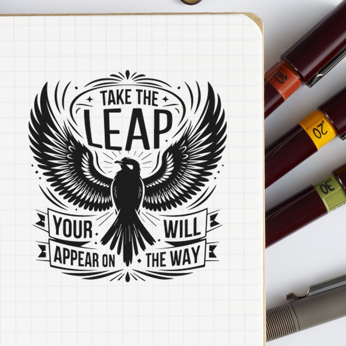 Black bird wing stamp on grid paper with Take the leap text, beside burgundy, yellow, and green seal stamps.